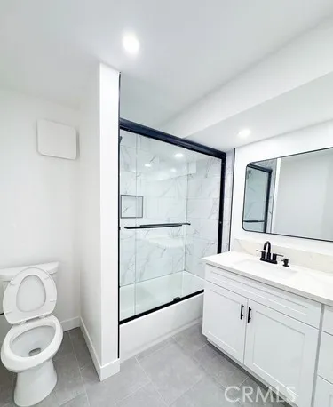 a kitchen with a sink cabinets and wooden floor