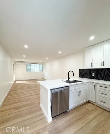 a large bedroom with a bed and a large cabinets