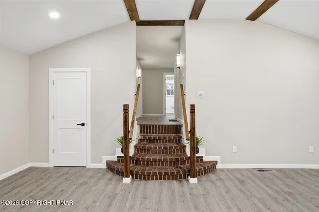 a view of an entryway with wooden floor