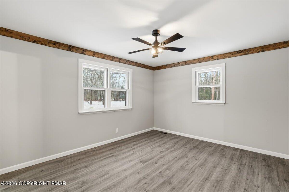 481 Wooddale Road East Stroudsburg, PA 18302 - Photo 17 of 37 a view of empty room with wooden floor and fan