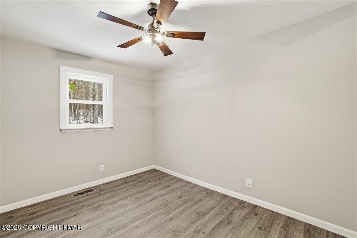 481 Wooddale Road East Stroudsburg, PA 18302 - Photo 19 of 37 an empty room with a window and a fan