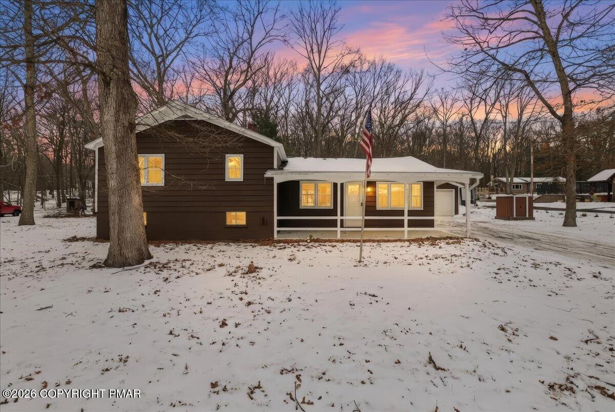 481 Wooddale Road East Stroudsburg, PA 18302 - Photo 2 of 37 a front view of a house with a yard covered in snow