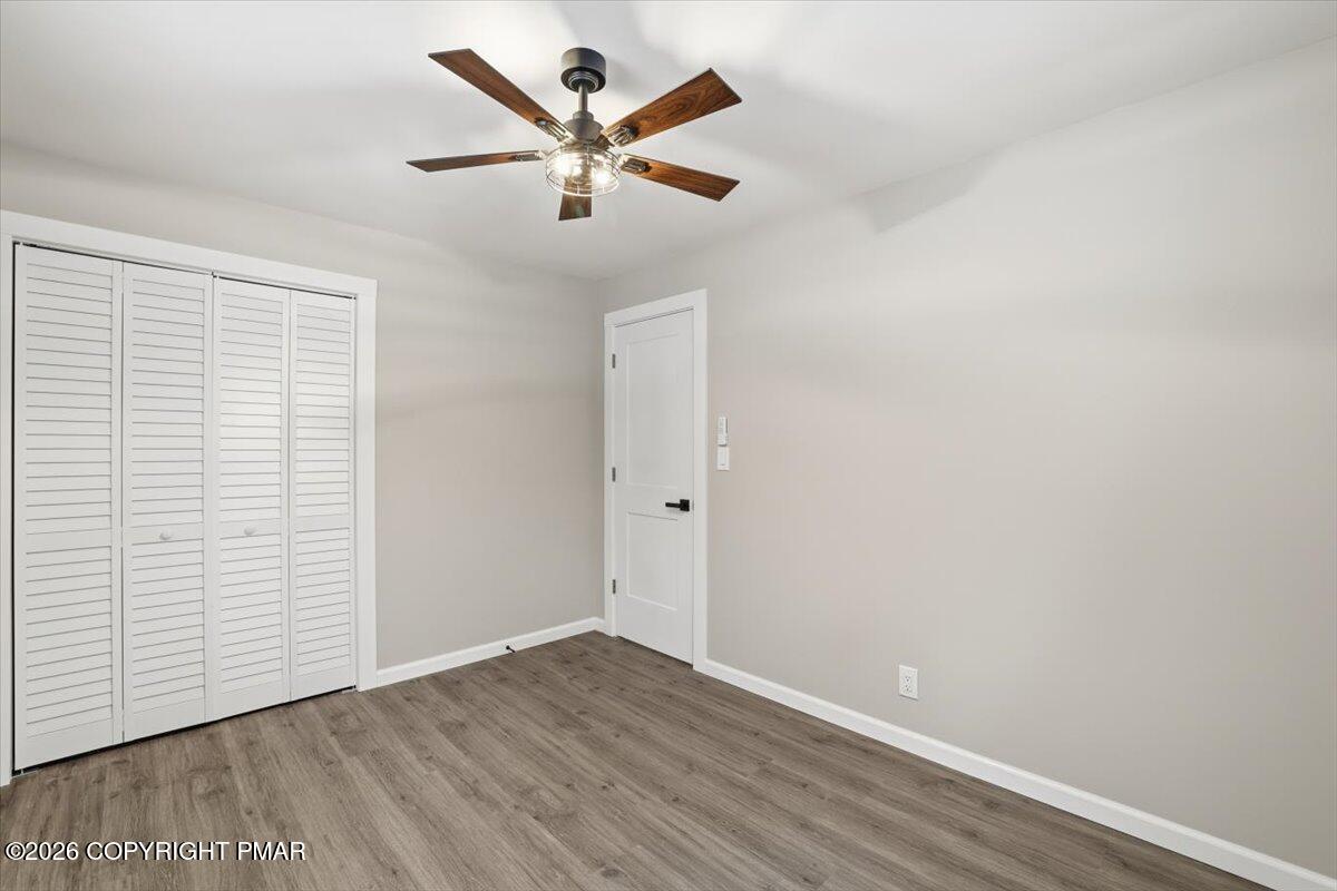 481 Wooddale Road East Stroudsburg, PA 18302 - Photo 22 of 37 an empty room with wooden floor and ceiling fan