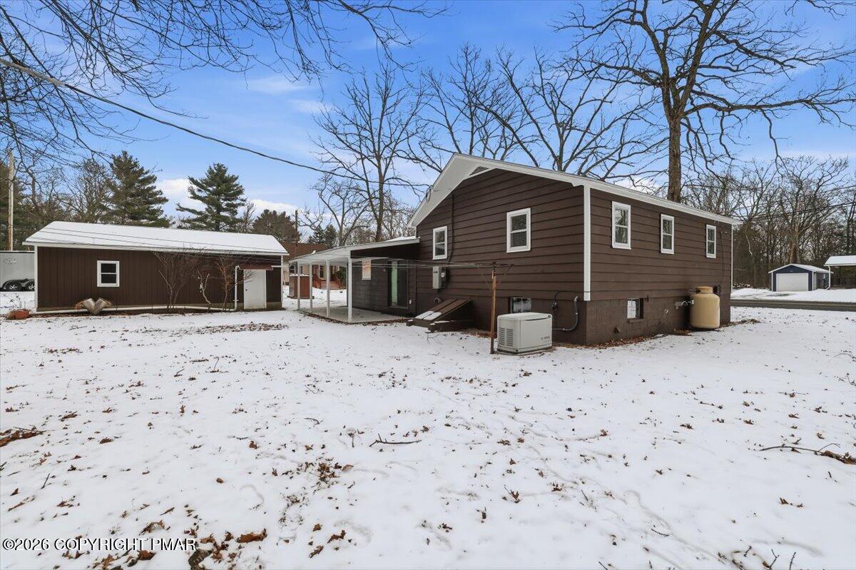 481 Wooddale Road East Stroudsburg, PA 18302 - Photo 3 of 37 a front view of a house with a yard covered in snow