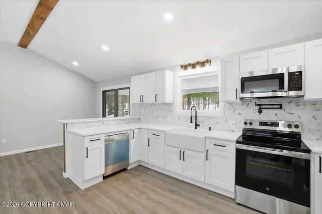 a kitchen with a sink stove and microwave