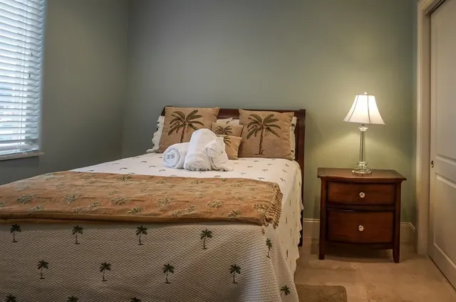 a bedroom with a bed and a lamp