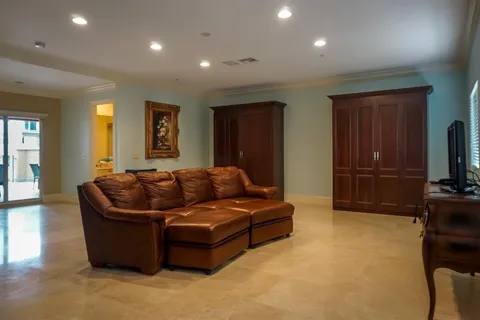a living room with furniture window and a flat screen tv