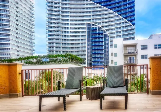 a balcony with table and chairs