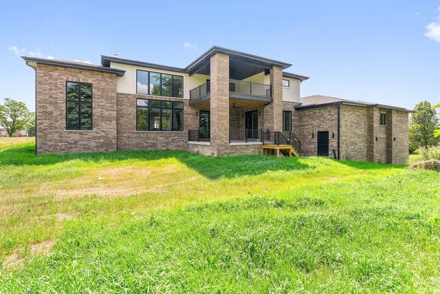 a view of a house with a yard and sitting area