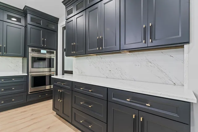 a kitchen with granite countertop stainless steel appliances and cabinets