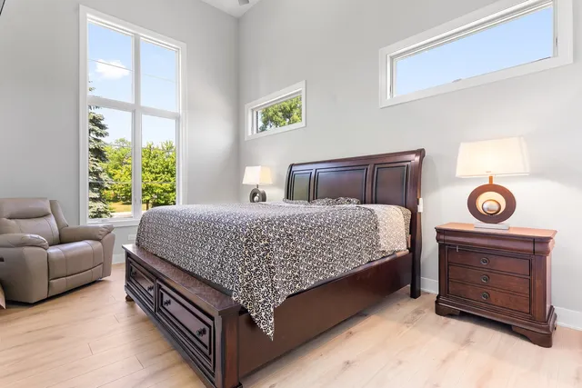 a bed room with a bed and a chair