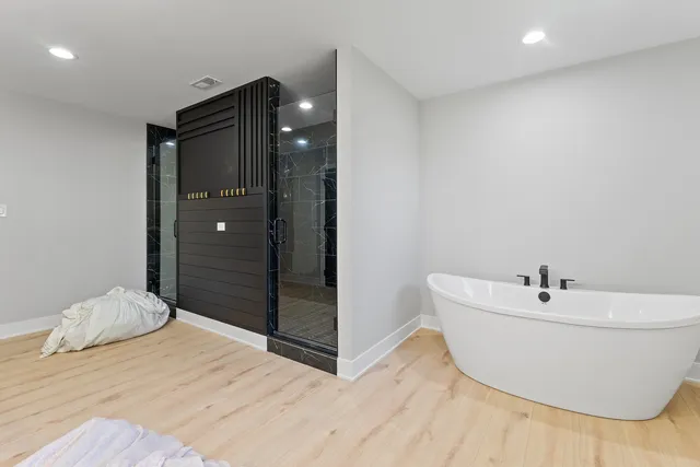 a bathroom with a bathtub and shower