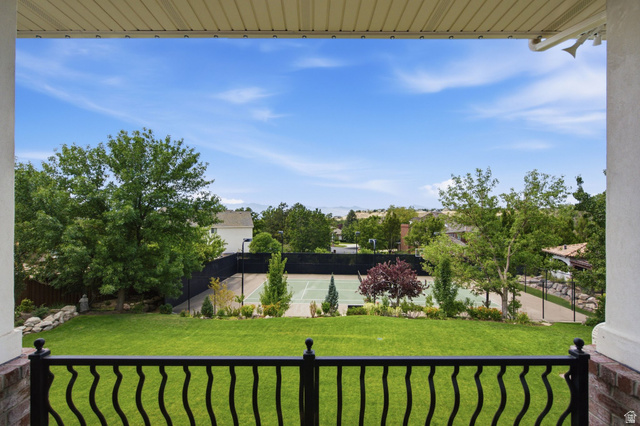 12308 Mariah Circle Draper, UT 84020 - Photo 234 of 293 Guest House Expansive backyard featuring a tennis court, manicured lawn, mature trees, and a black wrought iron railing