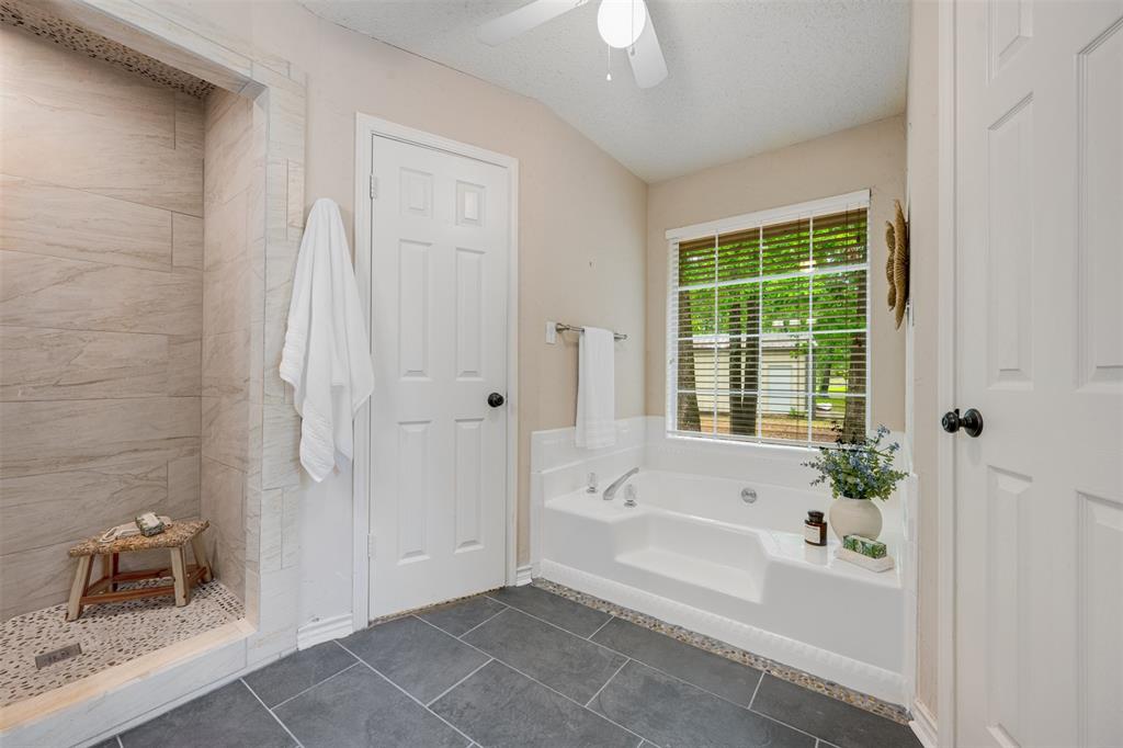 248 Butternut Lane Powderly, TX 75473 - Photo 23 of 40 a bathroom with a bathtub and a shower