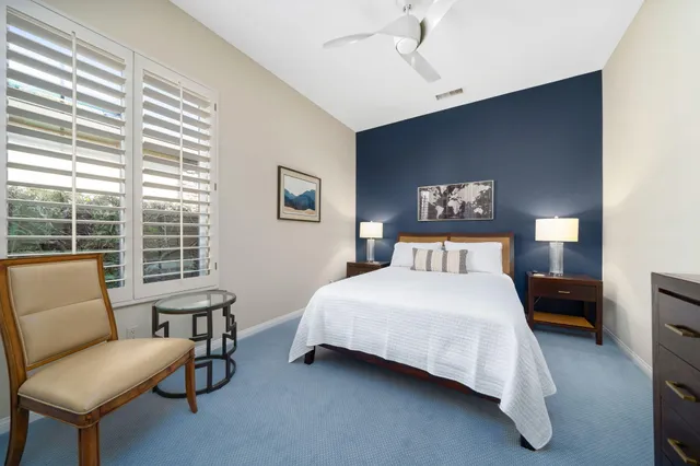 a view of two chairs in the patio