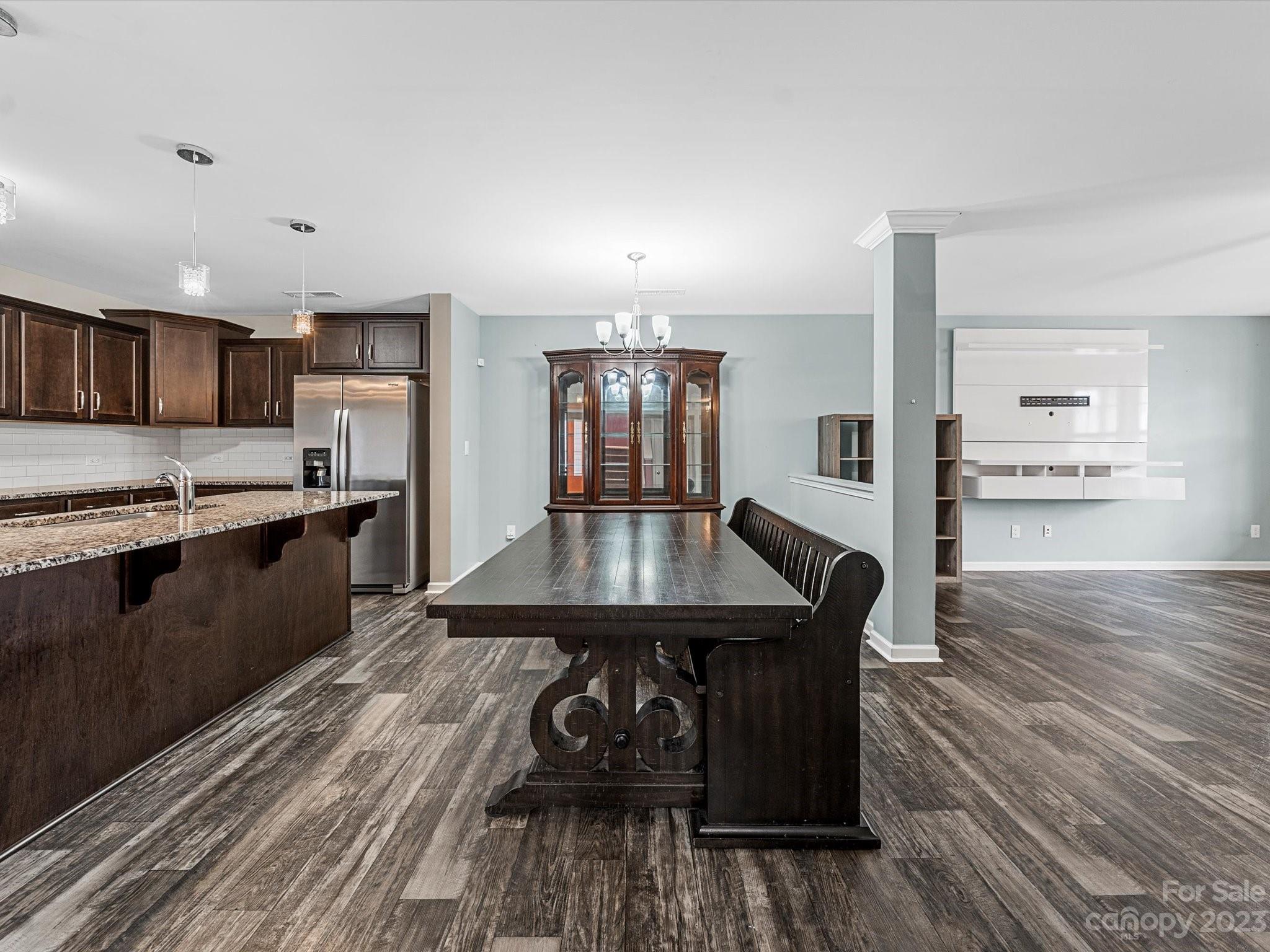 1142 Whitehall Hill Road York, SC 29745 - Photo 12 of 43 a kitchen with stainless steel appliances granite countertop a kitchen island hardwood floor sink stove dining table and chairs