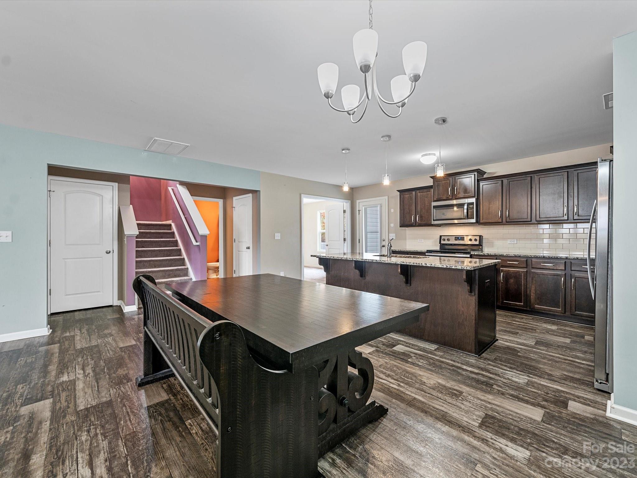 1142 Whitehall Hill Road York, SC 29745 - Photo 13 of 43 a kitchen with a table chairs stainless steel appliances and cabinets
