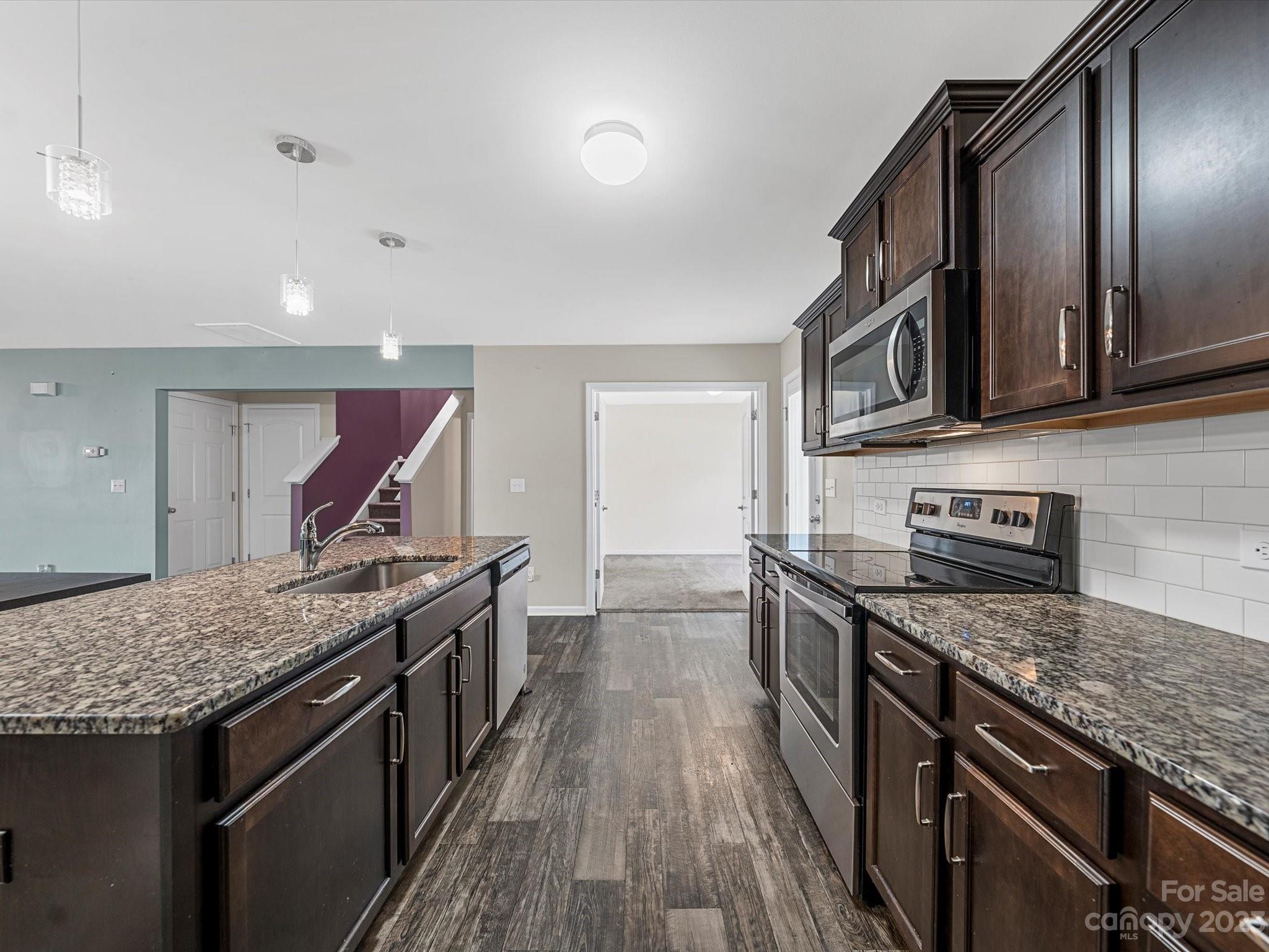 1142 Whitehall Hill Road York, SC 29745 - Photo 14 of 43 a kitchen with stainless steel appliances granite countertop a stove and a sink