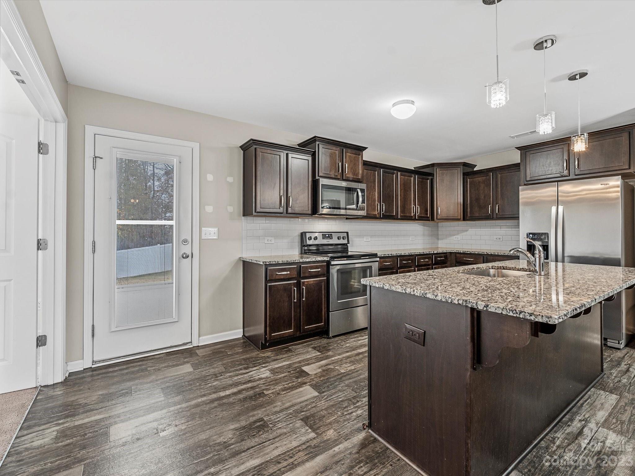 1142 Whitehall Hill Road York, SC 29745 - Photo 17 of 43 a kitchen with stainless steel appliances granite countertop a stove top oven a sink and a granite counter tops