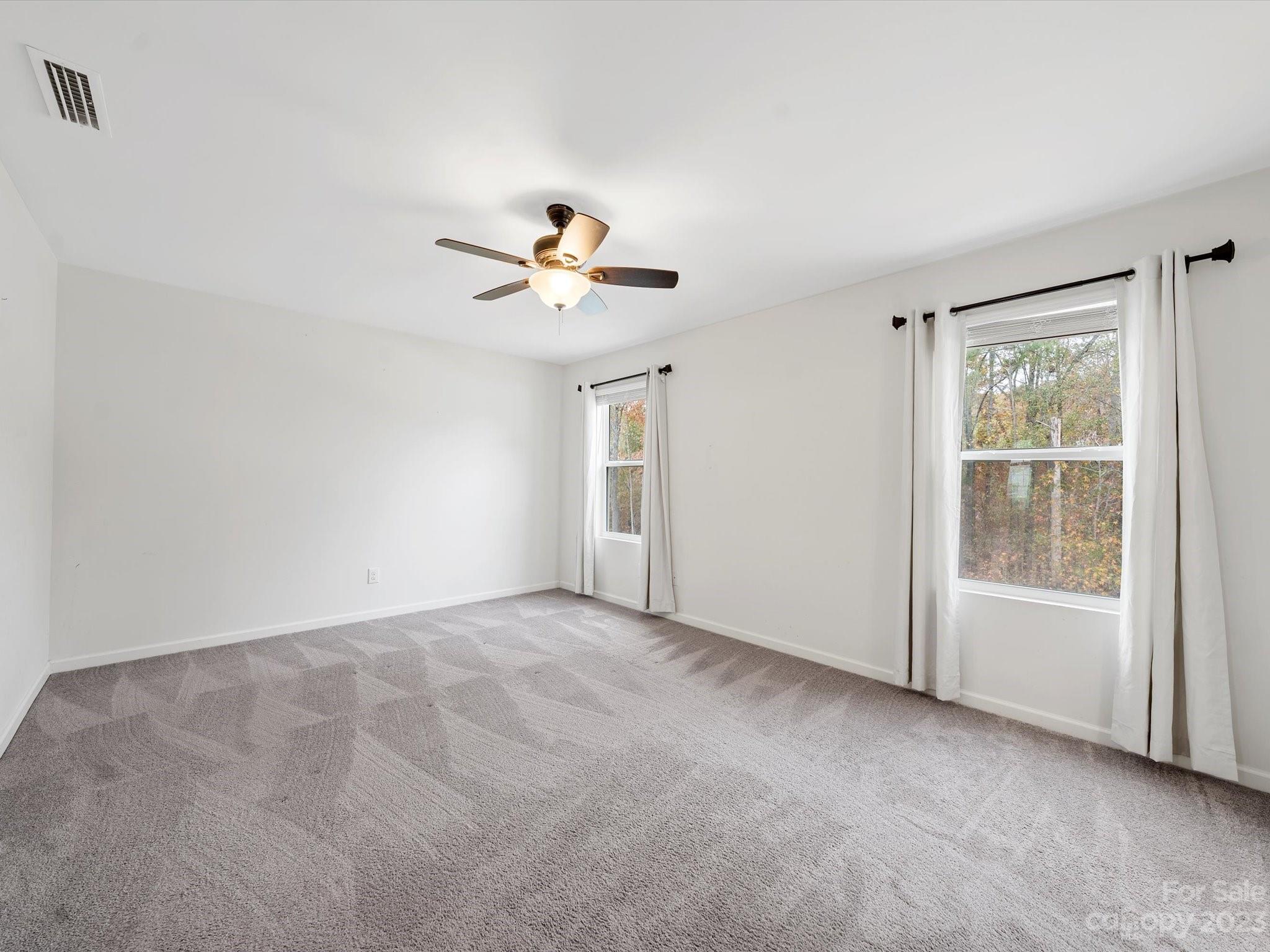 1142 Whitehall Hill Road York, SC 29745 - Photo 23 of 43 an empty room with windows and fan