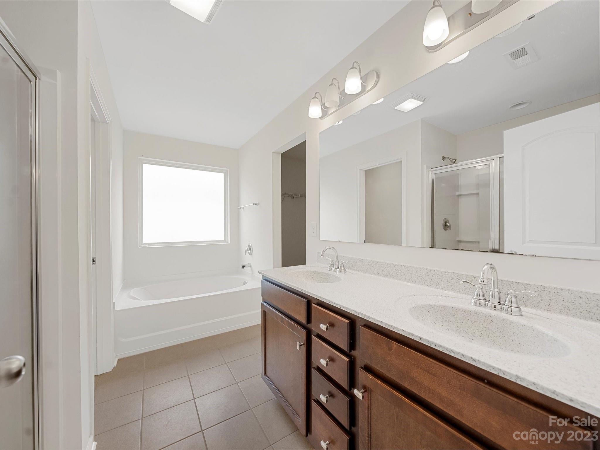 1142 Whitehall Hill Road York, SC 29745 - Photo 26 of 43 a bathroom with a sink double vanity granite tub shower and a mirror