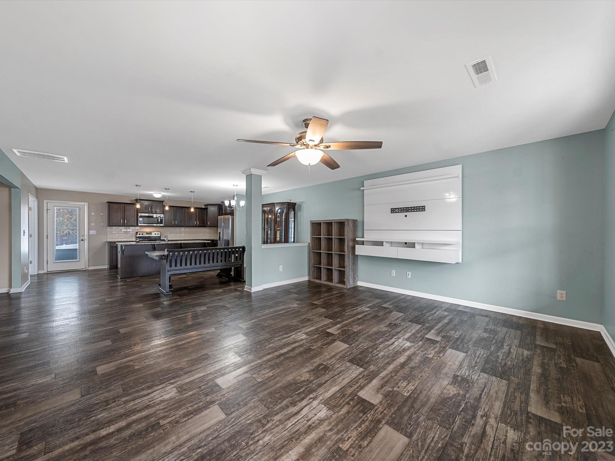 1142 Whitehall Hill Road York, SC 29745 - Photo 10 of 43 a view of a livingroom with furniture wooden floor a ceiling fan and window