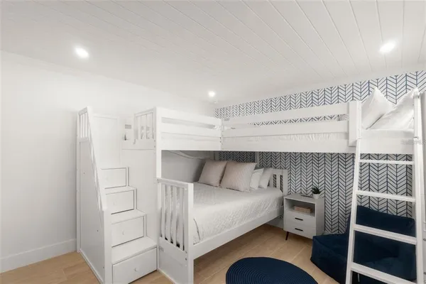 a bedroom with a bed and a chair