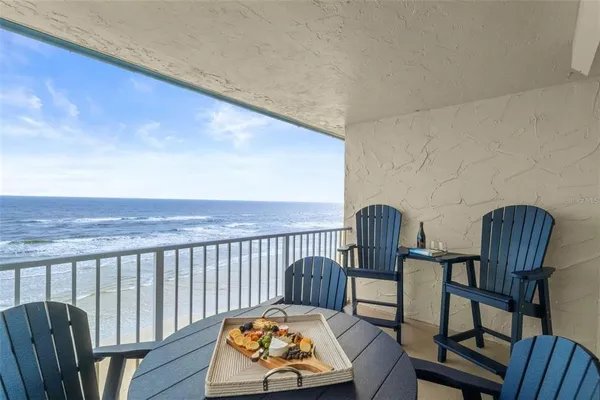 a view of a chair and table in the balcony