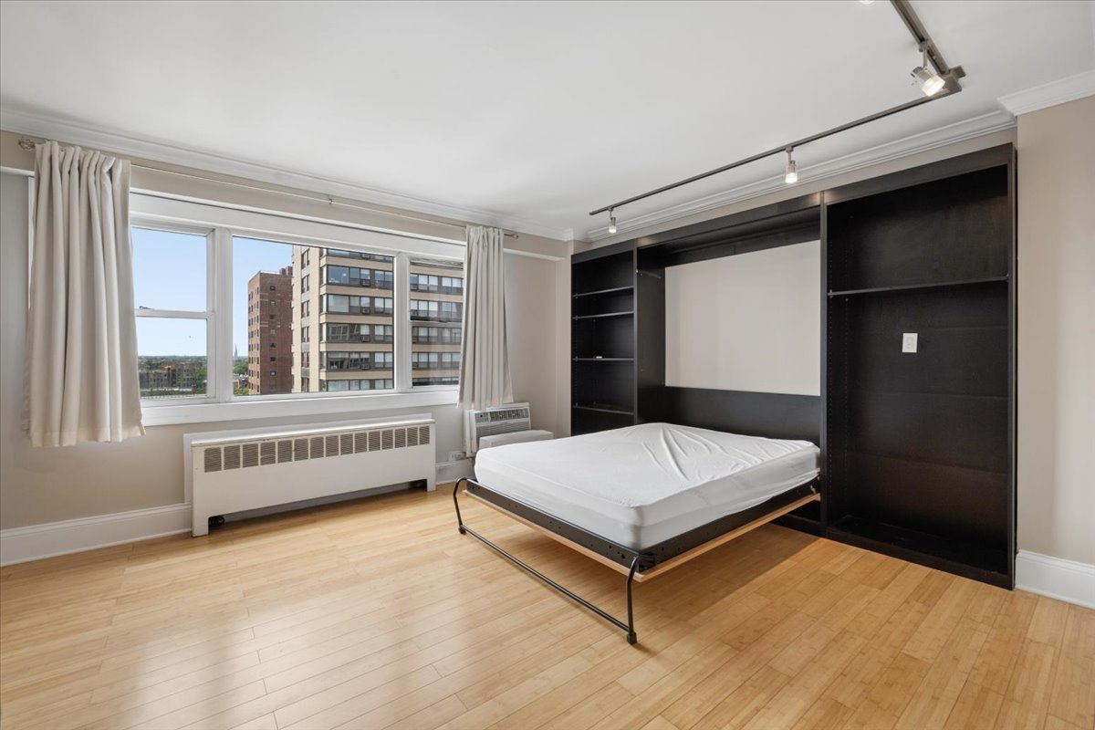 2909 North Sheridan Road, Unit 1201 Chicago, IL 60657 - Photo 3 of 16 a room with a bed and a window