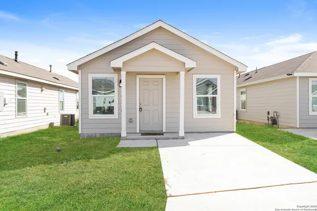 a view of a house with a yard and garden