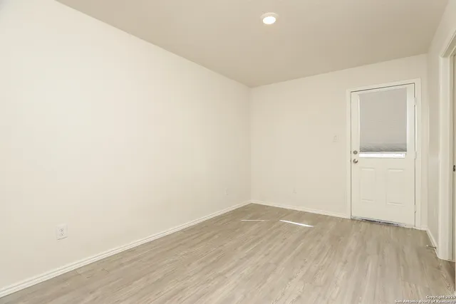 a view of a room with wooden floor