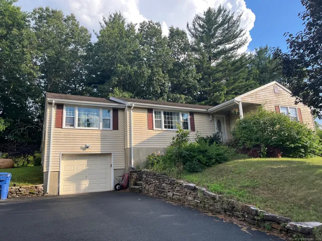 a view of house with outdoor space and garden