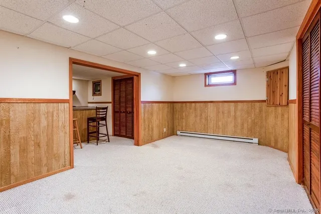 an empty room with furniture and a ceiling fan