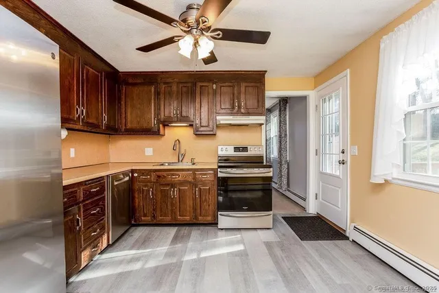 a kitchen with stainless steel appliances granite countertop a refrigerator and a sink