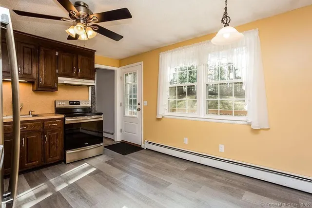 a kitchen with stainless steel appliances granite countertop a stove and a refrigerator