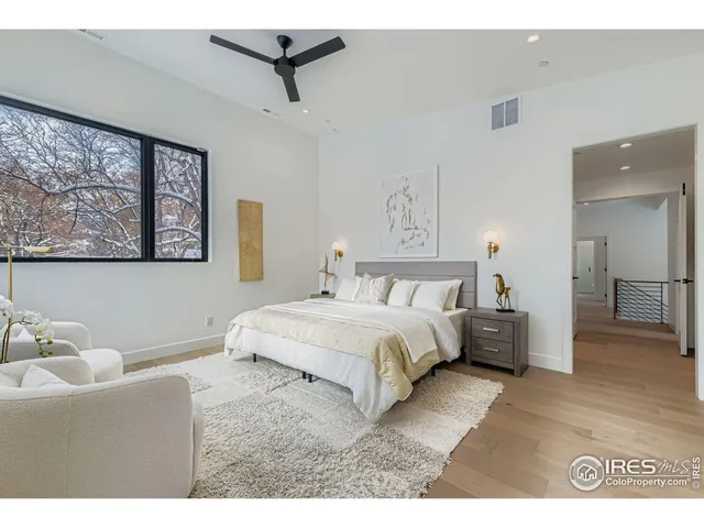 a bedroom with a bed and a painting on the wall