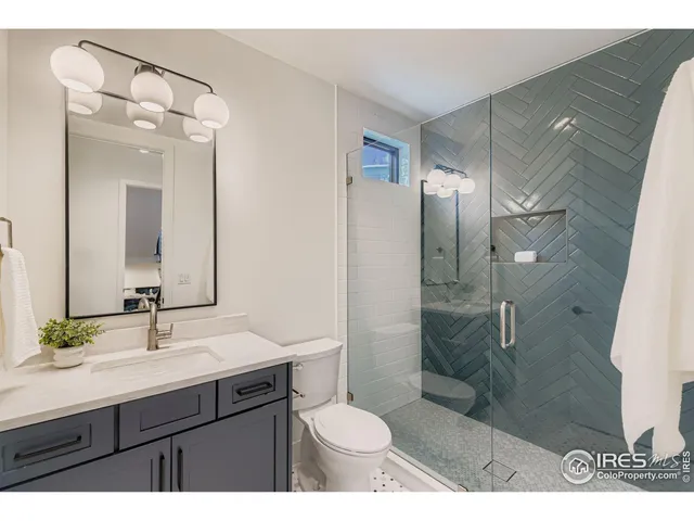 a bathroom with a sink shower and a toilet