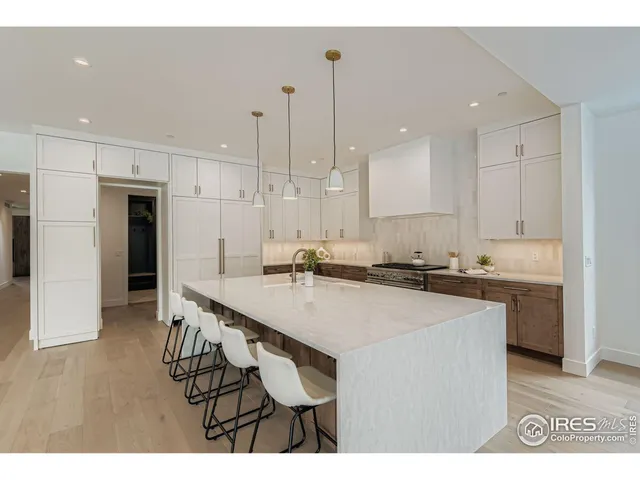 a kitchen with a sink a counter top space and stainless steel appliances