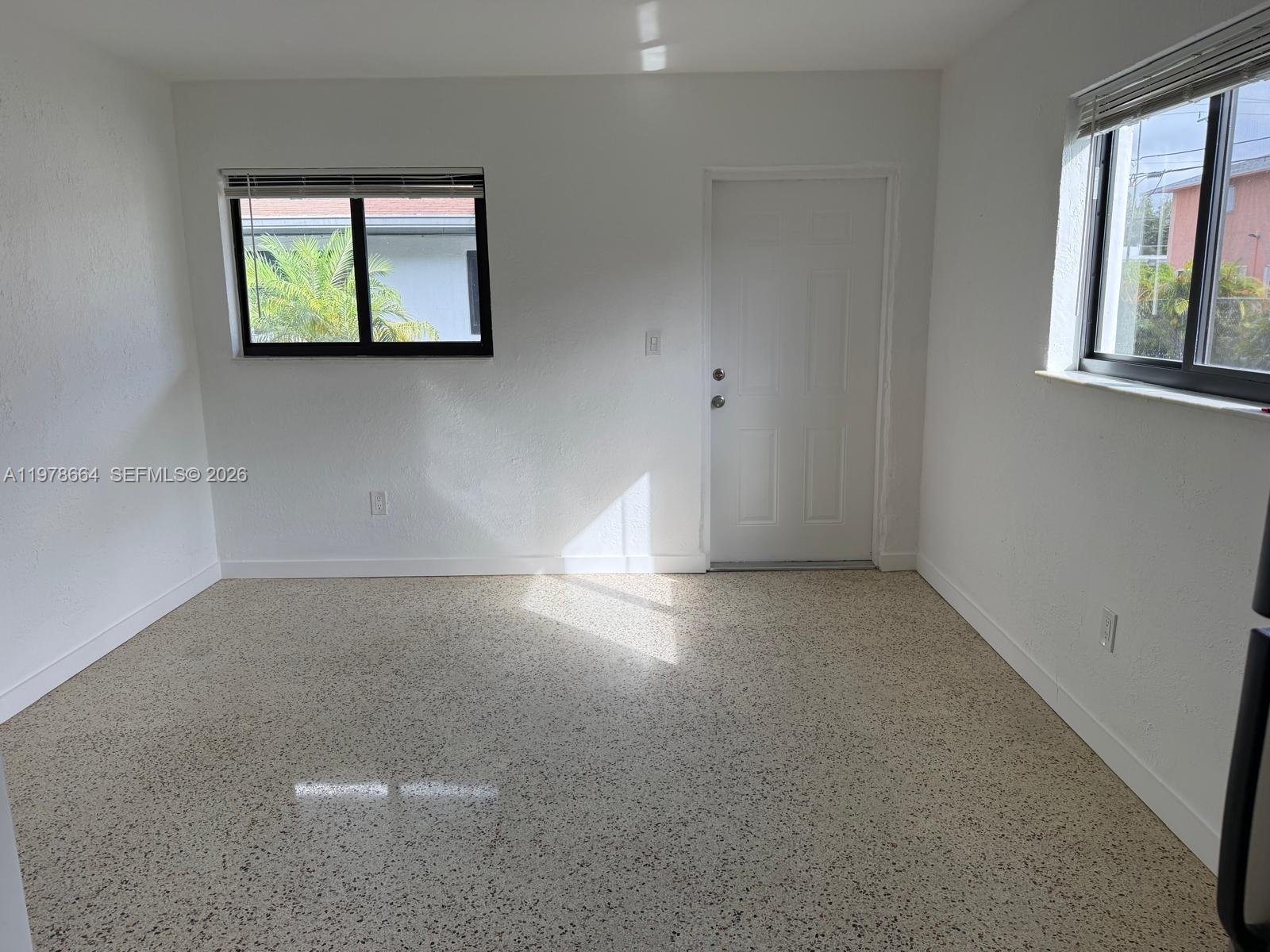 50 West 24th Street, Unit 4 Hialeah, FL 33010 - Photo 2 of 4 an empty room with windows