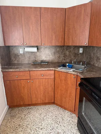 a kitchen with a sink cabinets and stainless steel appliances
