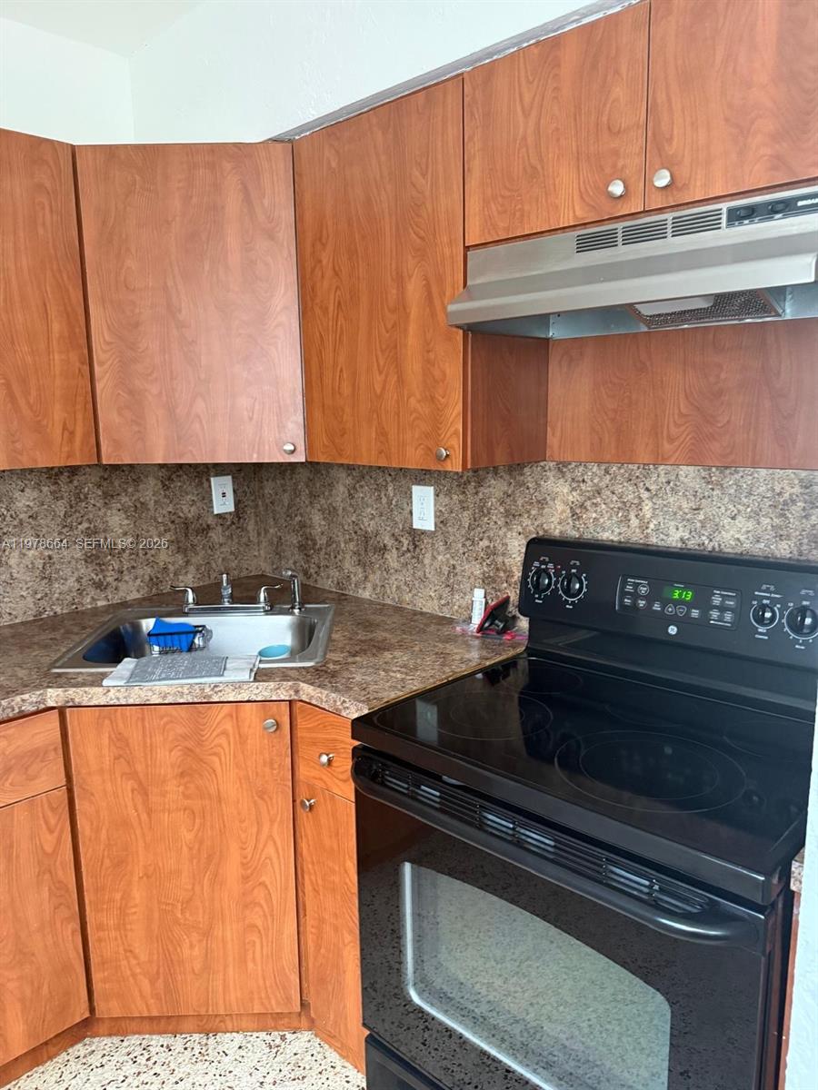 50 West 24th Street, Unit 4 Hialeah, FL 33010 - Photo 4 of 4 a kitchen with a stove and a microwave
