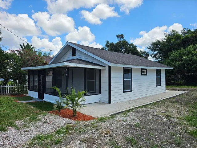 a front view of a house with a yard and porch