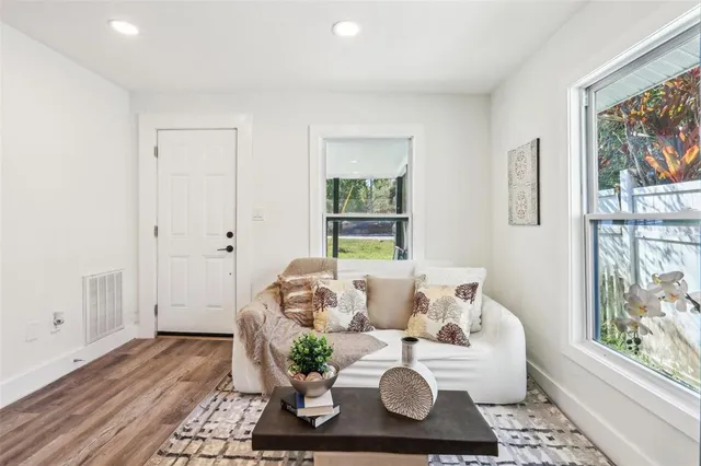 a living room with furniture and wooden floor