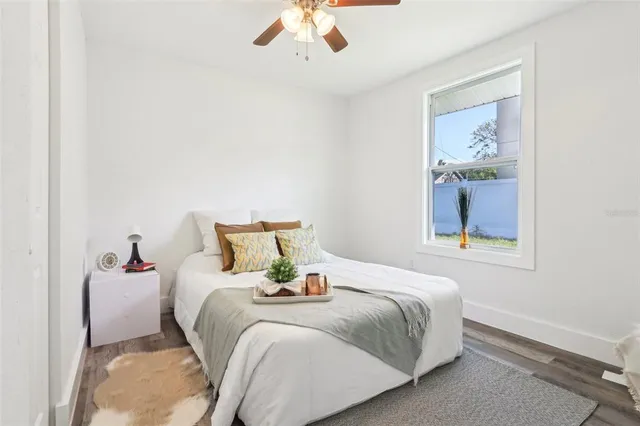 a bedroom with a bed and a painting on the wall