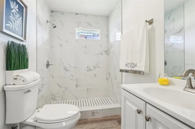 a bathroom with a sink a toilet and shower curtain