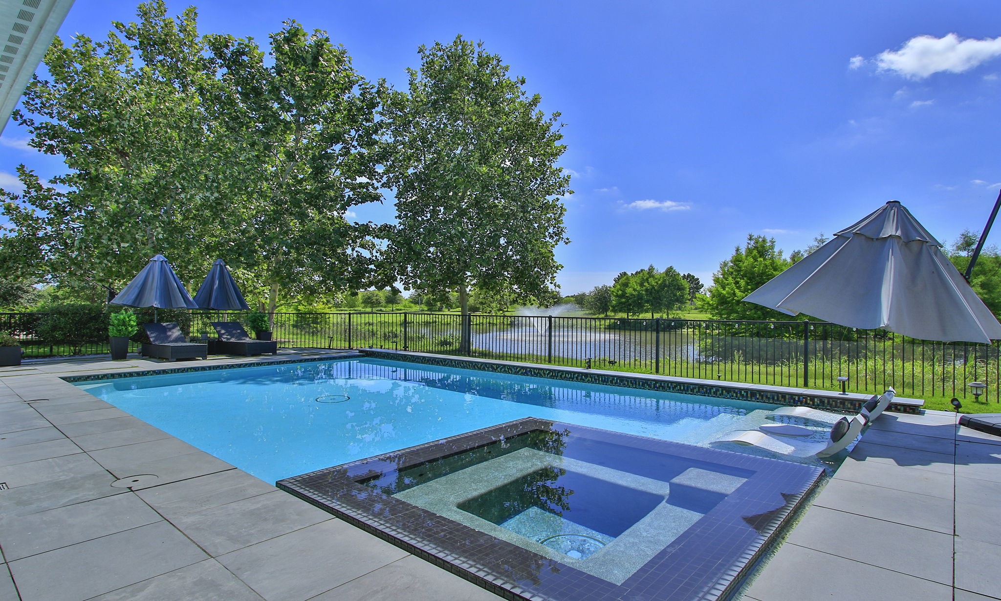 28518 Hoffman Spring Lane Fulshear, TX 77441 - Photo 40 of 50 Enjoy your sparkling heated pool and spa year round with great views of the lake.
