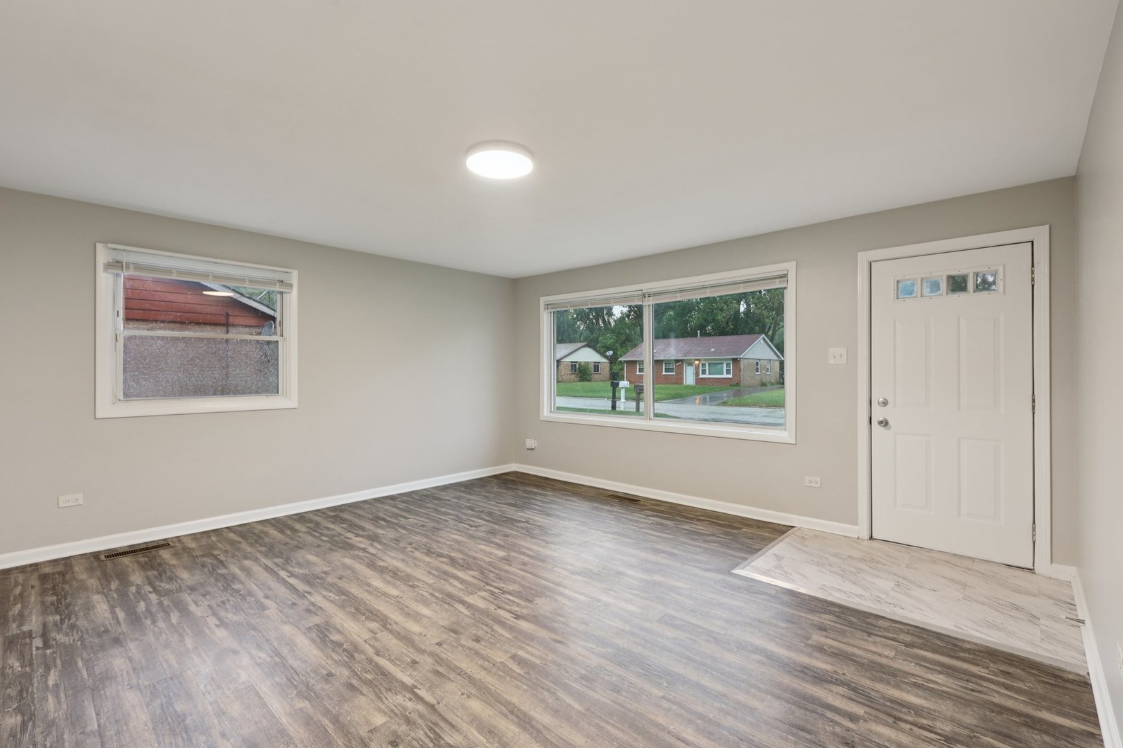 15364 Afton Avenue Markham, IL 60428 - Photo 2 of 23 a view of an empty room with wooden floor and a window