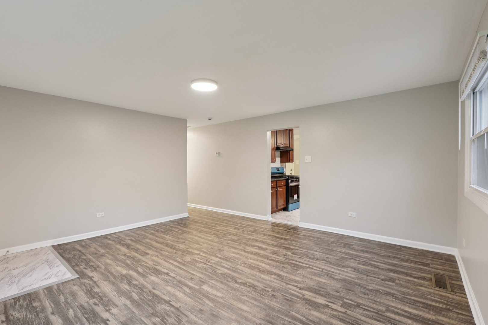 15364 Afton Avenue Markham, IL 60428 - Photo 4 of 23 a view of an empty room with wooden floor