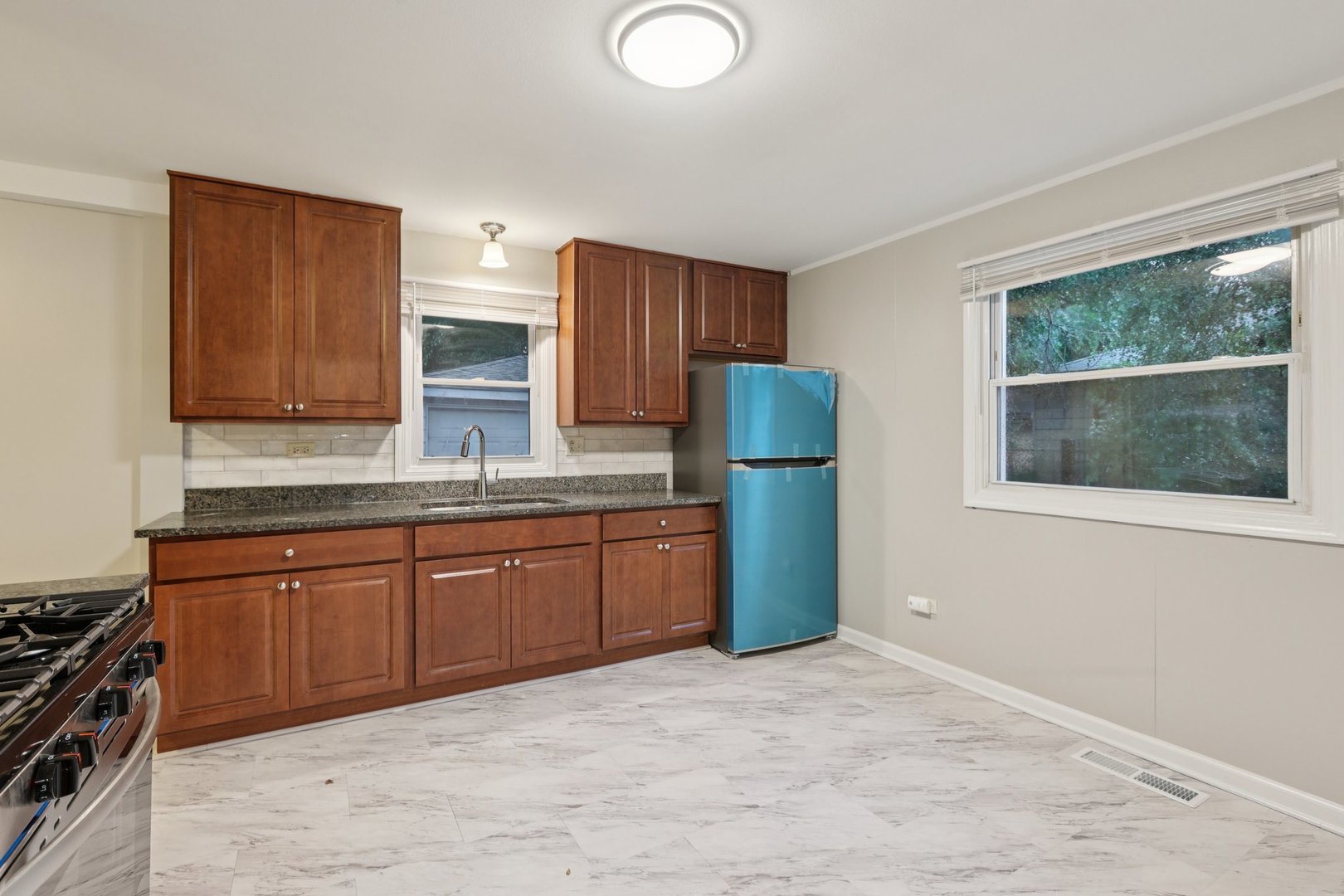 15364 Afton Avenue Markham, IL 60428 - Photo 5 of 23 a kitchen with stainless steel appliances granite countertop a refrigerator stove and microwave