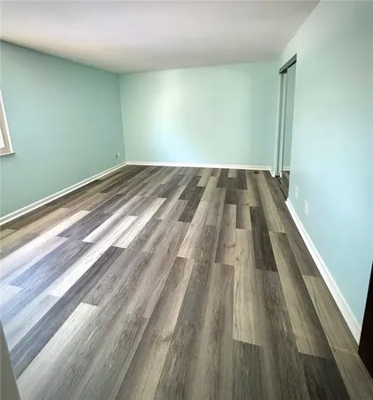 a view of a room with wooden floor